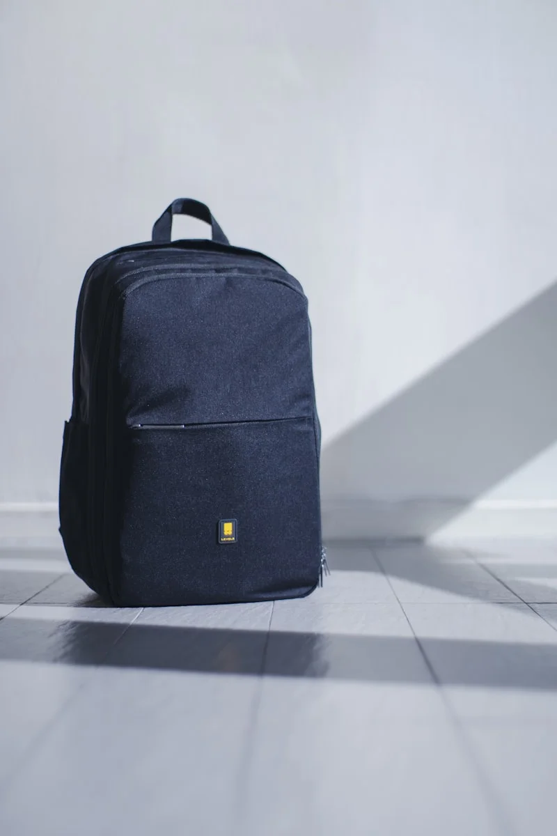 Neatly organized compact travel backpack packed with camera gear and light clothing