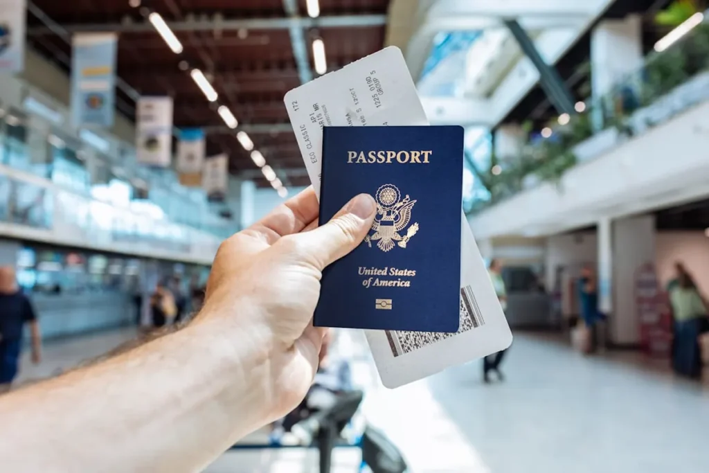 Passport, boarding pass, and travel credit card on airport lounge table