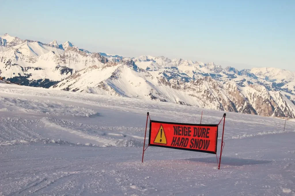 Hiker standing safely on scenic alpine peak with emergency backpack gear