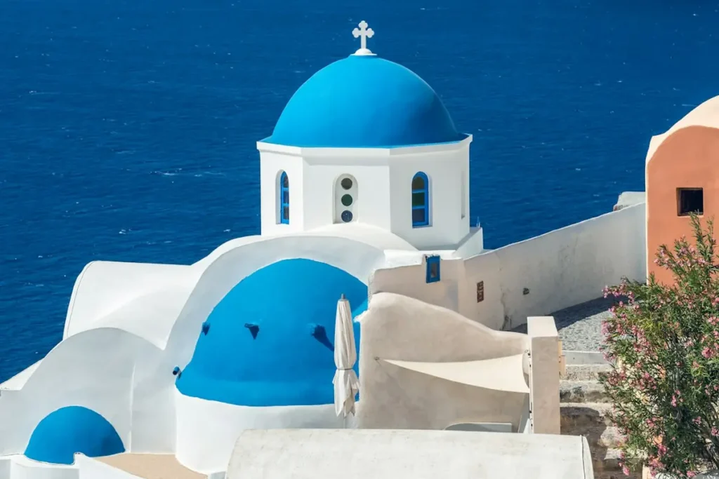 Historic cliffside coastal village overlooking turquoise Mediterranean sea in Southern Europe
