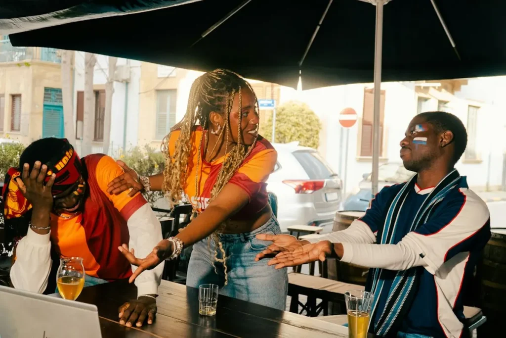 Group of international travelers sharing conversation and coffee at an outdoor cafe