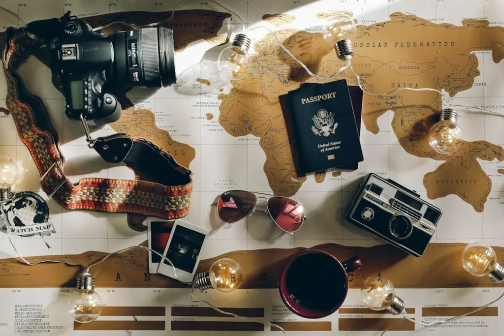 Travel planning desk with vintage map, passport, notebook, and compass