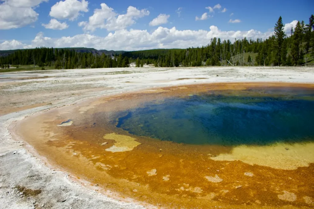 Scenic landscape of geyser and mountain valley in Yellowstone National Park