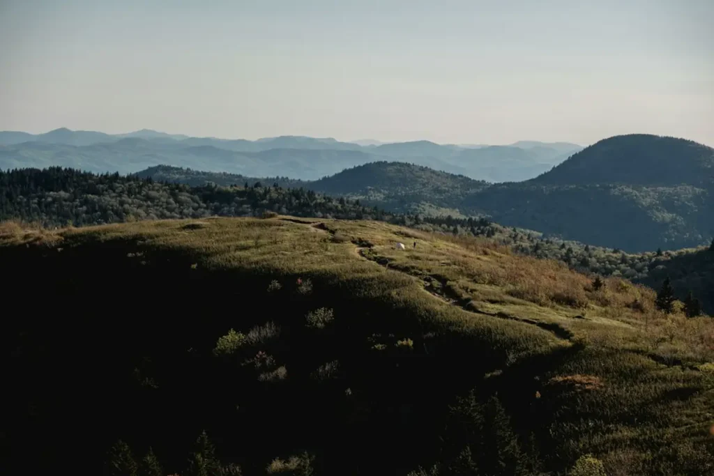 Backpacker camping with tent in wilderness mountain backcountry