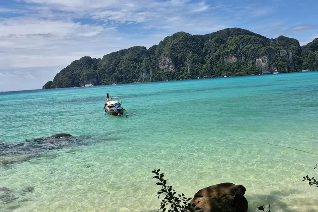 Tropical turquoise lagoon and towering limestone cliffs in Southeast Asia