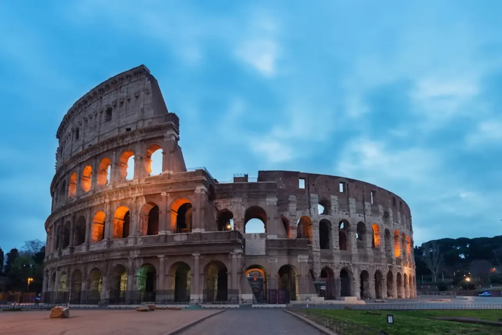 The historic Colosseum bathed in warm golden sunset light in Rome Italy